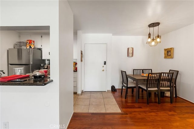 dining space with wood-type flooring