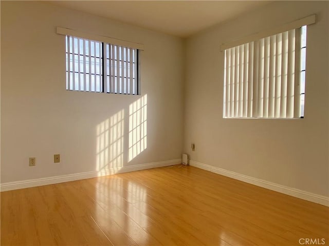 empty room with wood finished floors and baseboards