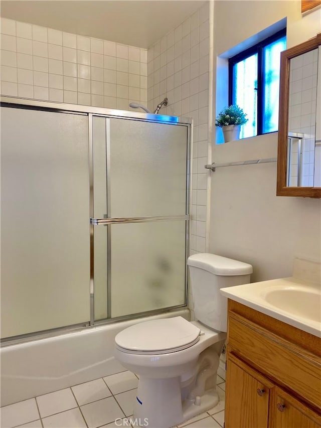 full bathroom with enclosed tub / shower combo, tile patterned floors, toilet, and vanity