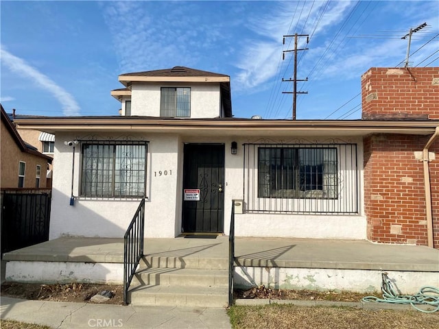 view of front of property with stucco siding and a porch