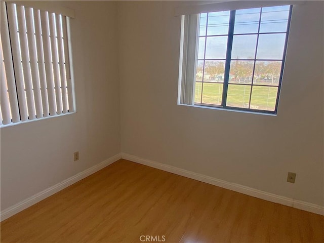 spare room with wood-type flooring