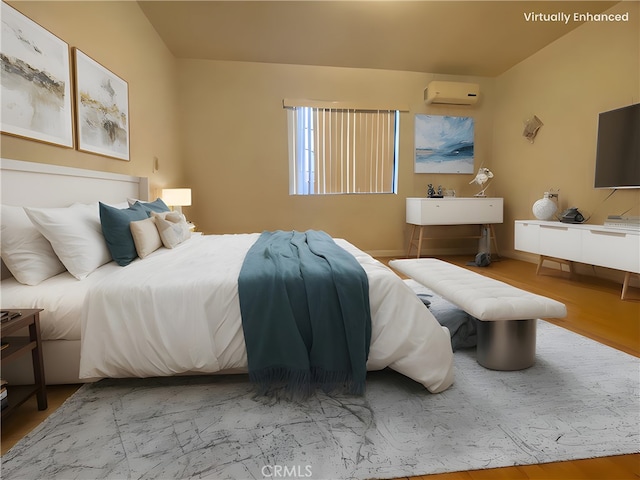 bedroom featuring wood-type flooring and a wall unit AC