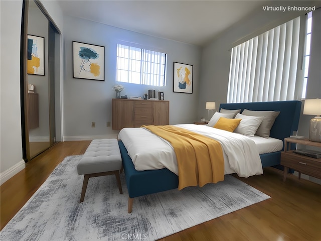 bedroom with wood finished floors and baseboards
