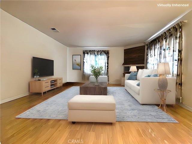 living area featuring wood finished floors and visible vents