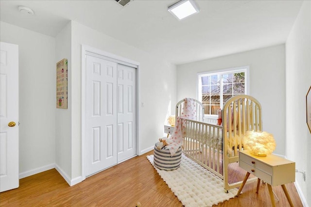 bedroom featuring light hardwood / wood-style flooring and a closet