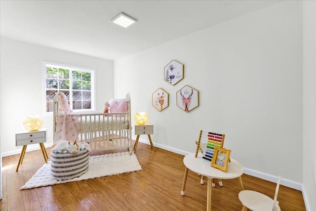 bedroom with hardwood / wood-style flooring