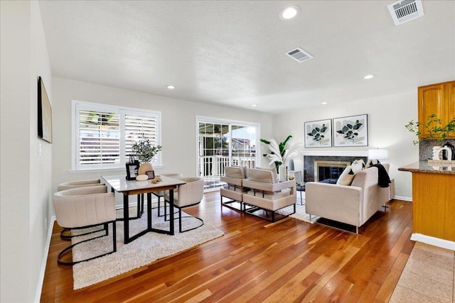 living room with a premium fireplace and hardwood / wood-style floors