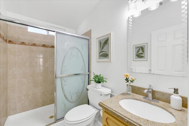 bathroom featuring walk in shower, vanity, and toilet