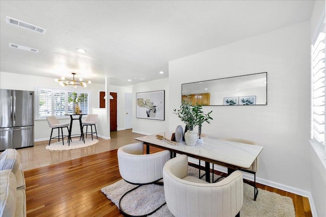 dining area featuring a chandelier and light hardwood / wood-style floors