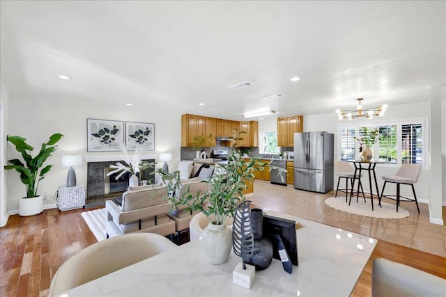 living room featuring light hardwood / wood-style flooring and a chandelier