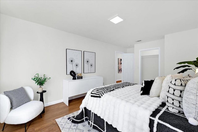 bedroom featuring hardwood / wood-style floors and a closet