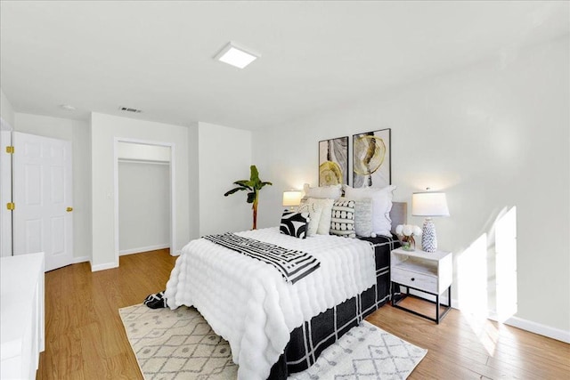 bedroom with hardwood / wood-style flooring and a closet