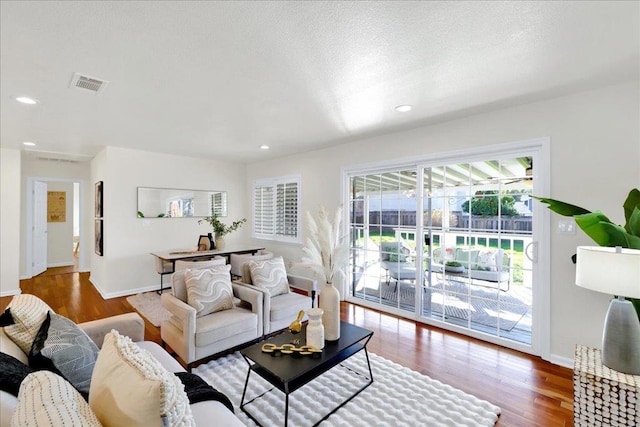 living room featuring hardwood / wood-style flooring and a textured ceiling