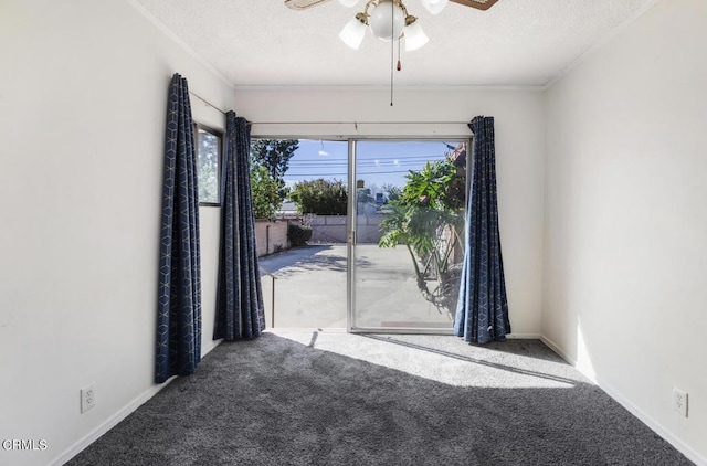 spare room featuring ceiling fan, ornamental molding, carpet flooring, and a textured ceiling