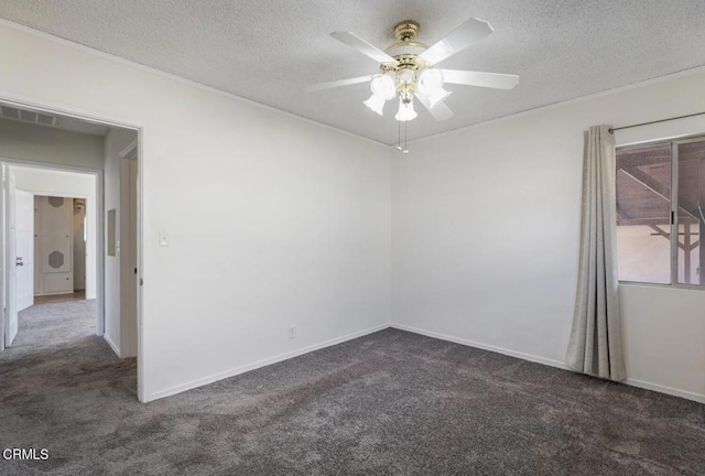 carpeted spare room featuring ceiling fan and a textured ceiling