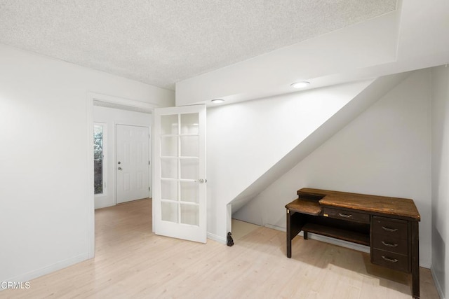 interior space featuring light hardwood / wood-style flooring and a textured ceiling