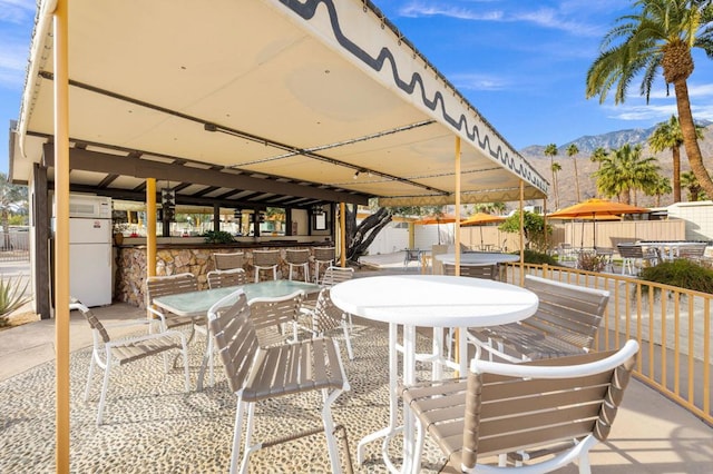 view of patio / terrace with a mountain view and an outdoor bar