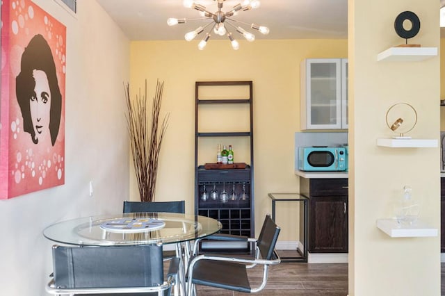 dining space with a notable chandelier and dark wood-type flooring