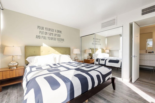 bedroom featuring hardwood / wood-style flooring and a closet