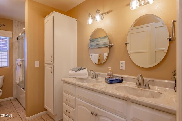 full bathroom with enclosed tub / shower combo, vanity, toilet, and tile patterned flooring