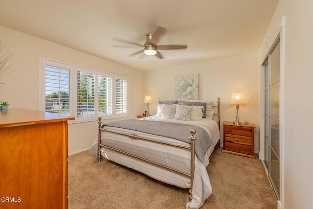 bedroom with light colored carpet and ceiling fan