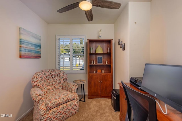 living area with light colored carpet and ceiling fan