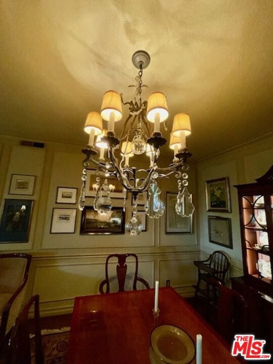 dining area featuring a notable chandelier and crown molding