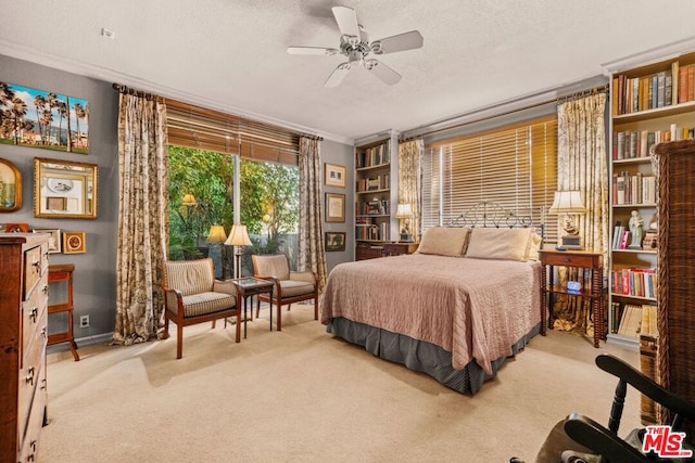 bedroom with ceiling fan, light colored carpet, ornamental molding, and a textured ceiling