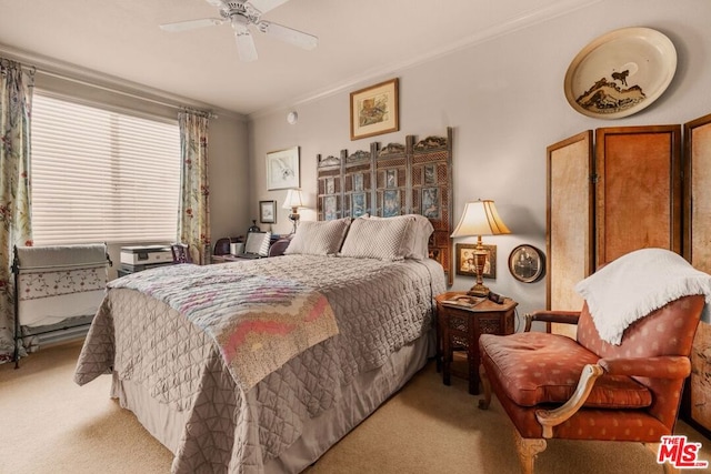 carpeted bedroom featuring ornamental molding and ceiling fan