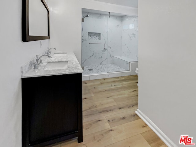 bathroom featuring vanity, hardwood / wood-style flooring, toilet, and walk in shower