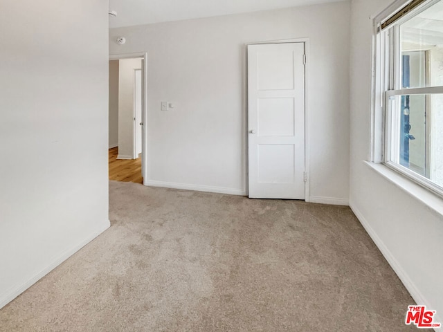 carpeted empty room featuring a healthy amount of sunlight