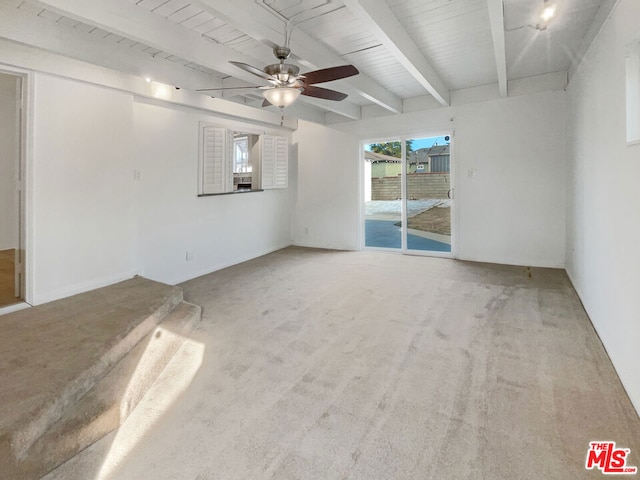 carpeted empty room featuring ceiling fan, beam ceiling, wooden ceiling, and a healthy amount of sunlight