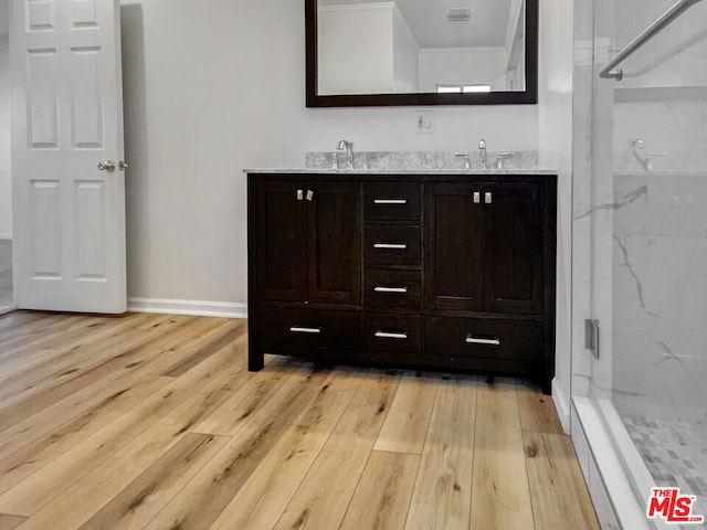 bathroom featuring vanity, wood-type flooring, and walk in shower