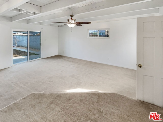 carpeted empty room featuring ceiling fan and beam ceiling