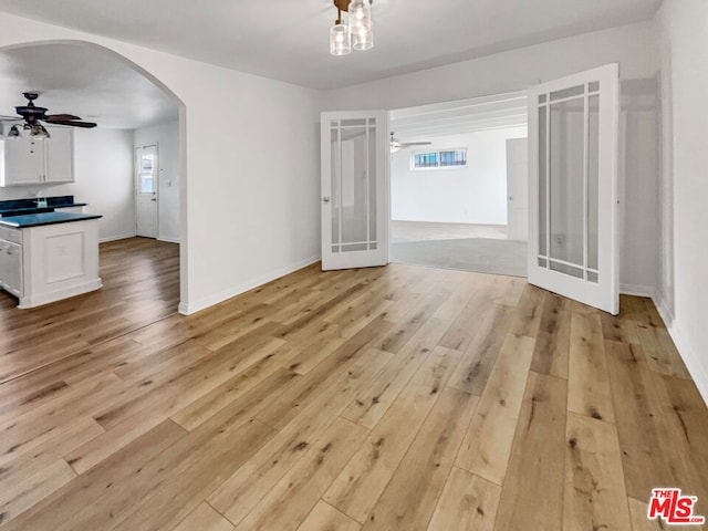 unfurnished room featuring light hardwood / wood-style flooring, french doors, and ceiling fan