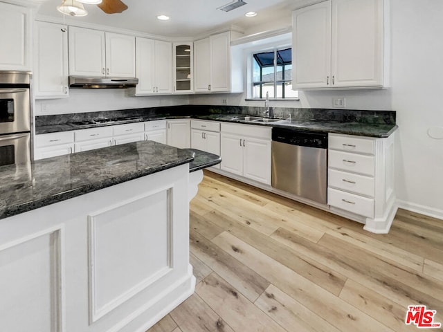 kitchen with white cabinetry, appliances with stainless steel finishes, light hardwood / wood-style floors, and sink