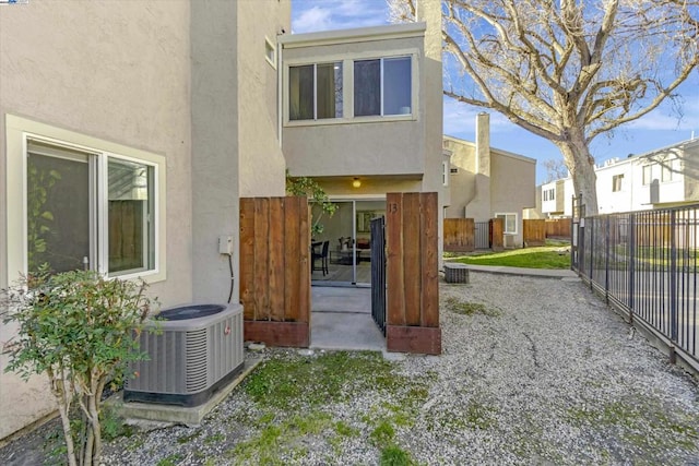 rear view of property with a patio and central AC