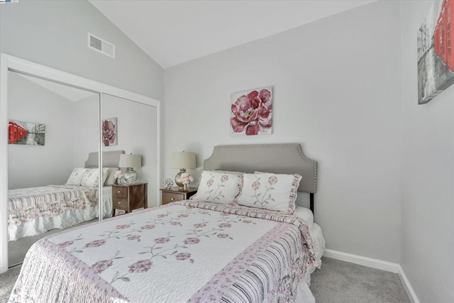 bedroom featuring vaulted ceiling, carpet flooring, and a closet