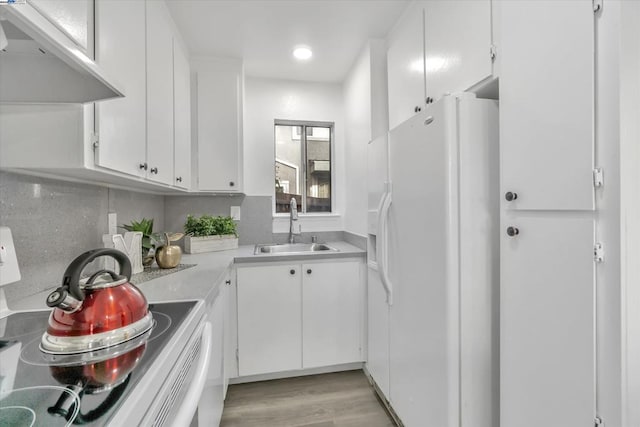 kitchen featuring sink, white appliances, range hood, tasteful backsplash, and white cabinets