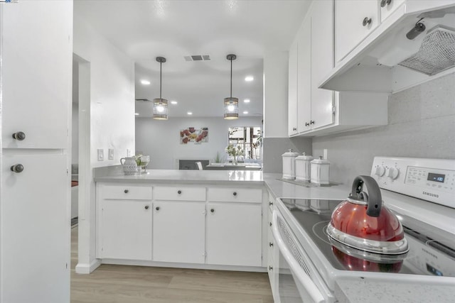 kitchen with white cabinetry, decorative light fixtures, light hardwood / wood-style flooring, electric range, and kitchen peninsula