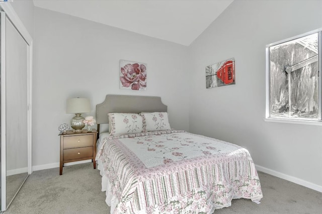 bedroom with light colored carpet and vaulted ceiling