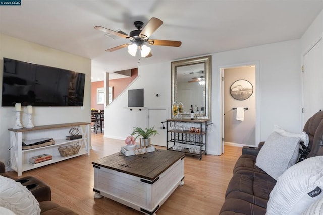 living room with ceiling fan and light hardwood / wood-style floors