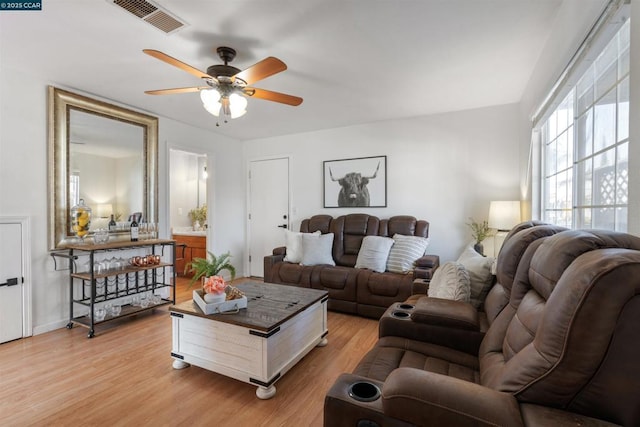 living room featuring light hardwood / wood-style floors and ceiling fan