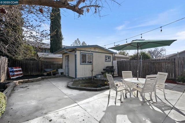 view of patio / terrace featuring area for grilling and an outbuilding