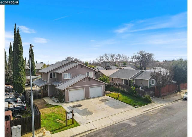 view of front of house featuring a garage and a front lawn