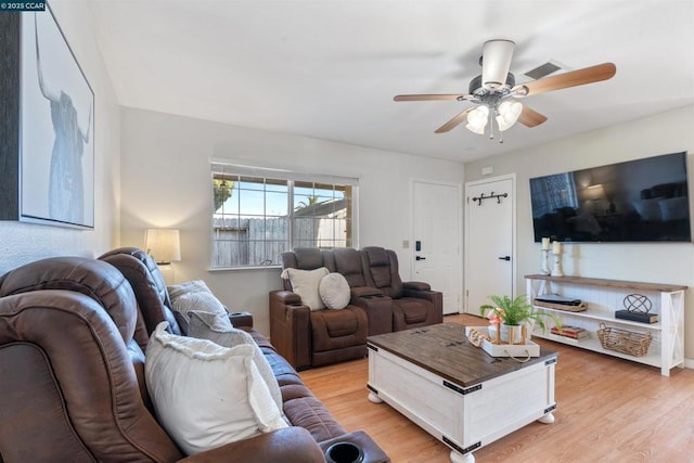 living room with ceiling fan and light hardwood / wood-style flooring