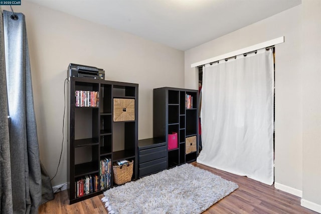 bedroom with dark hardwood / wood-style flooring