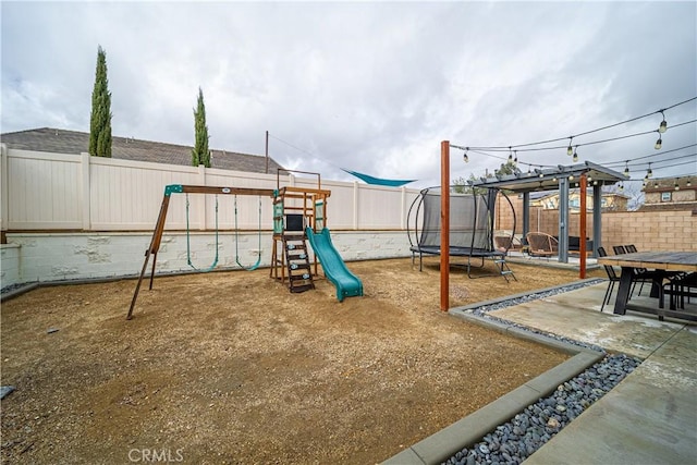 view of play area featuring a patio and a trampoline