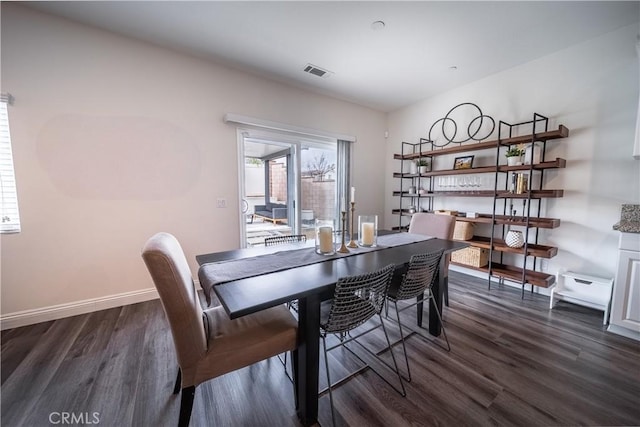 dining space featuring a baseboard radiator and dark hardwood / wood-style flooring