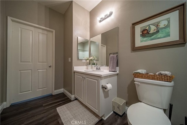 bathroom with vanity, hardwood / wood-style floors, and toilet